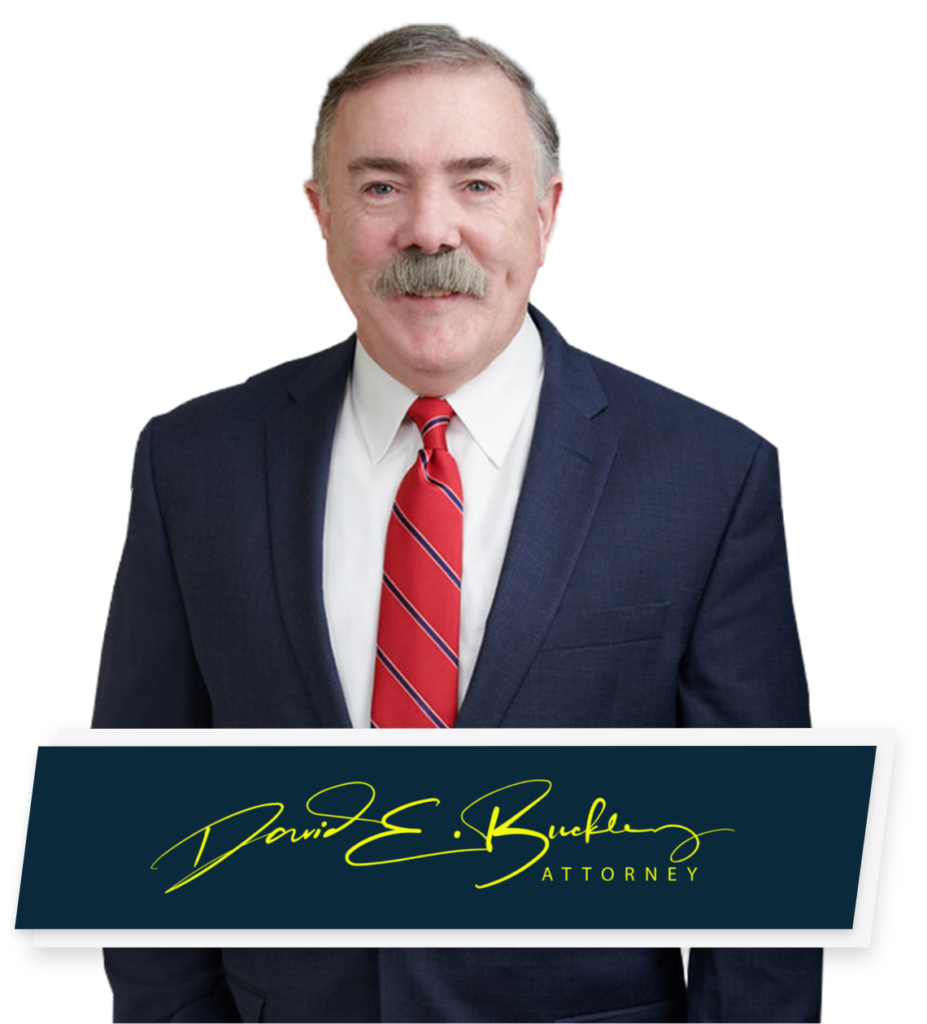 Pelham NH Car Accident Lawyer David Buckley poses for headshot with signature below 