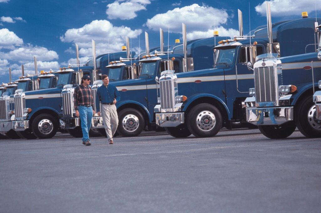 Pelham Truck Accident Lawyer features photo of commercial trucks lined up and parked on lot to demonstrate size of large trucks